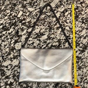 JCrew Silver envelope clutch with chain strap.